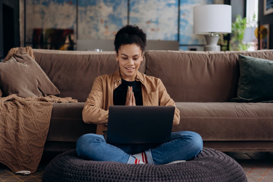 Person working at a laptop in a cozy modern home office space.